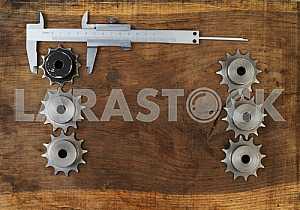 Different construction tools on a wooden background - screwdriver, caliper.