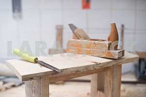 Different construction tools on a wooden background - screwdriver, caliper.