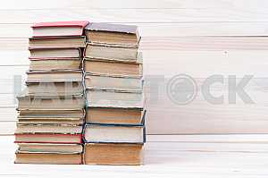 Stack of hardback books on wooden table. Back to school. Copy space
