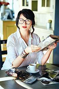A girl with glasses and a magazine