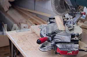 Different construction tools on a wooden background - screwdriver, caliper.
