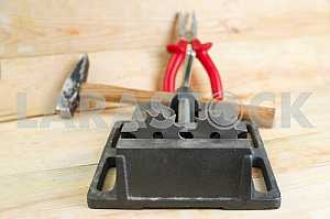 Different construction tools on a wooden background - screwdriver, caliper.