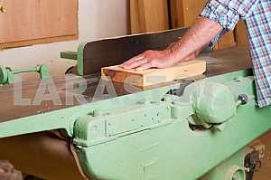 Carpenter tools on wooden table with sawdust. Circular Saw. Carpenter workplace top view