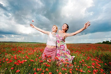 Two girls in a poppy field