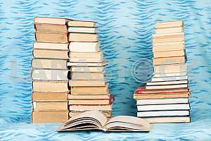 Old and used hardback books or text books on wooden table. Books and reading are essential for self improvement, gaining knowledge and success in our careers, business and personal lives. Copy space