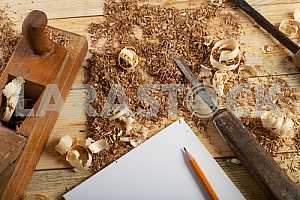Carpenter tools on wooden table with sawdust. Circular Saw.