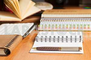 Stack of hardback books on wooden table. Back to school. Copy space. Top view