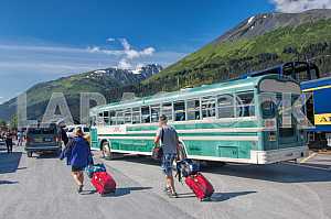 Tourists with their luggage near the bus