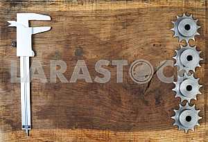 Different construction tools on a wooden background - screwdriver, caliper.