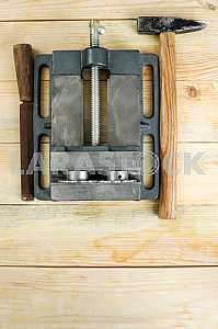 Different construction tools on a wooden background - screwdriver, caliper.