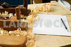 Carpenter tools on wooden table with sawdust. Circular Saw.