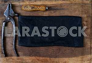 Different construction tools on a wooden background - screwdriver, caliper.