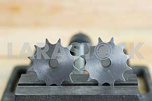 Different construction tools on a wooden background - screwdriver, caliper.
