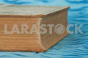 Old and used hardback books or text books on wooden table. Books and reading are essential for self improvement, gaining knowledge and success in our careers, business and personal lives. Copy space