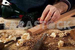 Carpenter tools on wooden table with sawdust. Circular Saw.