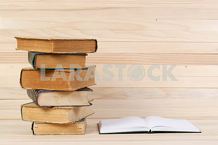 Stack of hardback books on wooden table. Back to school.