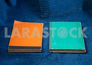 Open book, stack of hardback books on wooden table. Back to school. Copy space