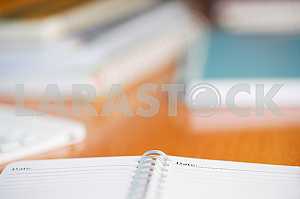 Stack of hardback books on wooden table. Back to school. Copy space. Top view