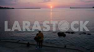 Couple admiring the sunset from the embankment in Sevastopol