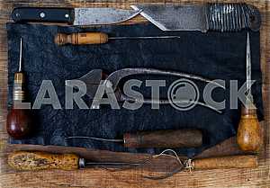 Different construction tools on a wooden background - screwdriver, caliper.