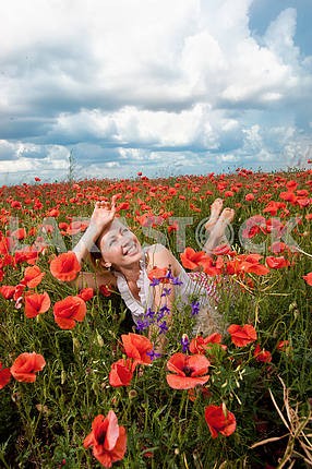 Girl in a field of poppies