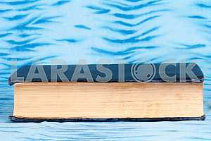Old and used hardback books or text books on wooden table. Books and reading are essential for self improvement, gaining knowledge and success in our careers, business and personal lives. Copy space