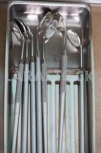 Stomatological instrument in the dentists clinic. Operation, tooth replacement.
