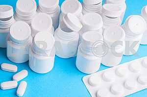 Many pills and tablets isolated on light blue background