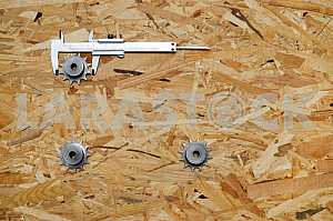 Different construction tools on a wooden background - screwdriver, caliper.