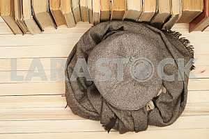 On a wooden table books, documents, calculator, red briefcase.