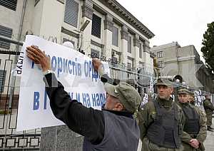 Activists hold placards