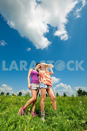 two girlfriends having fun in blue sky