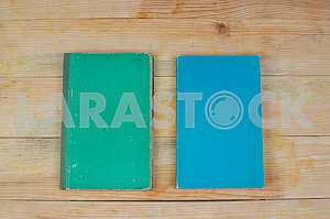Open book, stack of hardback books on wooden table. Back to school. Copy space