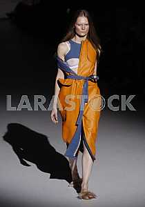 Model on a dark background shows outfit by Ukrainian designer Katya Silchenko