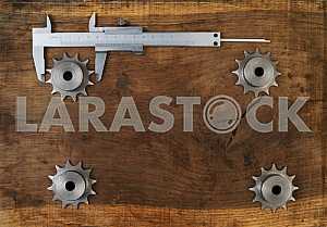 Different construction tools on a wooden background - screwdriver, caliper.