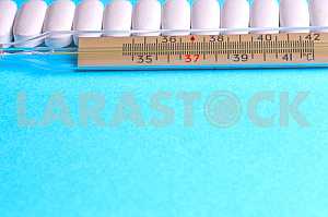 Many pills and tablets isolated on light blue background