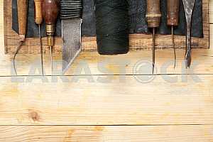 Carpenter tools on wooden table with sawdust. Circular Saw.