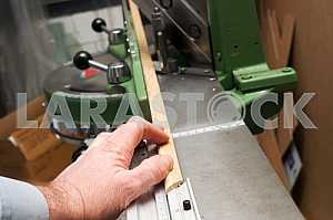 Different construction tools on a wooden background - screwdriver, caliper.