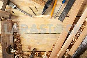 Carpenter tools on wooden table with sawdust. Circular Saw.