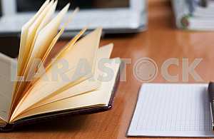 Stack of hardback books on wooden table. Back to school. Copy space. Top view