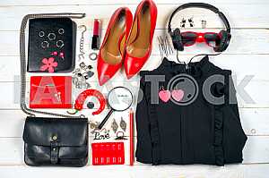 Women clothing set and accessories on white wooden background.