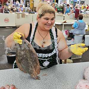 A woman sells fish in the market "Privoz"