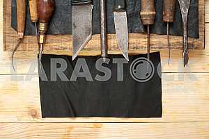 Carpenter tools on wooden table with sawdust. Circular Saw.