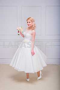 Blonde beautiful bride in short dress with wedding bouquet