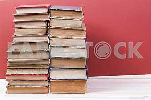 Stack of hardback books on wooden table. Back to school. Copy space