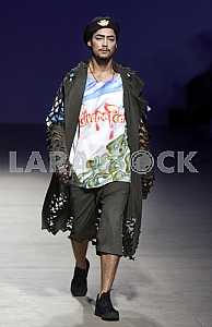 The model wlaks during demonstrates outfit by Ukrainian designer Sofia Rousinovich