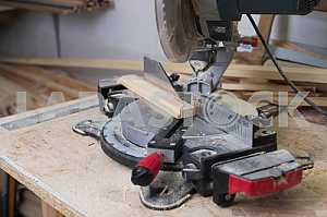 Different construction tools on a wooden background - screwdriver, caliper.