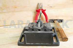 Different construction tools on a wooden background - screwdriver, caliper.