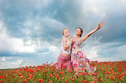 two girls in a poppy field