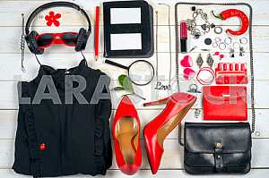 Women clothing set and accessories on white wooden background.